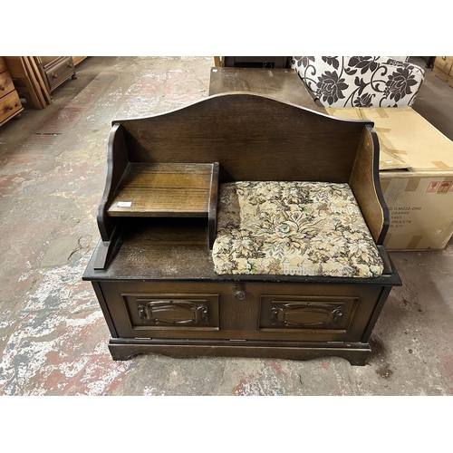 107 - A carved oak and floral upholstered telephone seat - approx. 76cm high x 81cm wide x 43cm deep