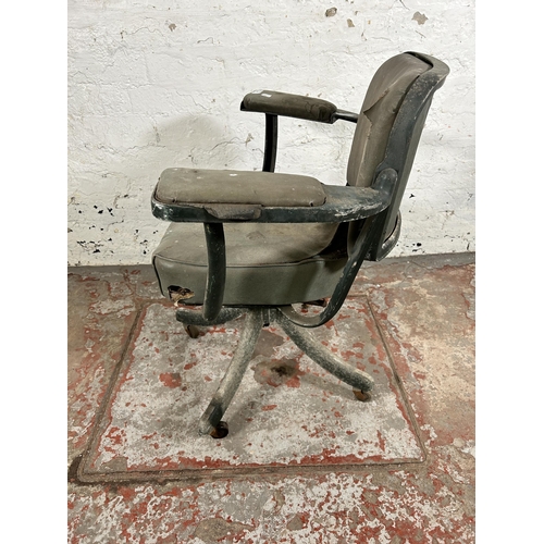 108 - A mid 20th century green metal and vinyl industrial swivel office desk chair stamped 