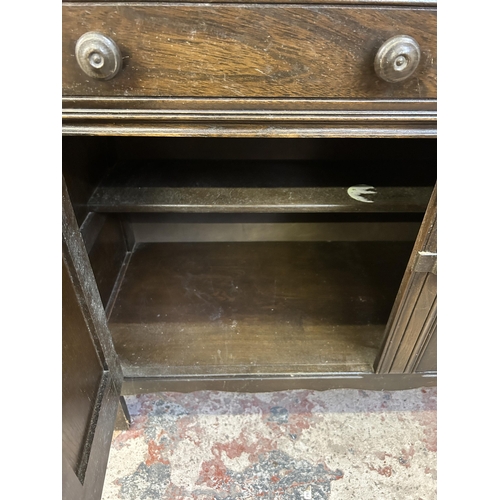 11 - An Ercol Old Colonial dark elm dresser - approx. 162cm high x 120cm wide x 48cm deep