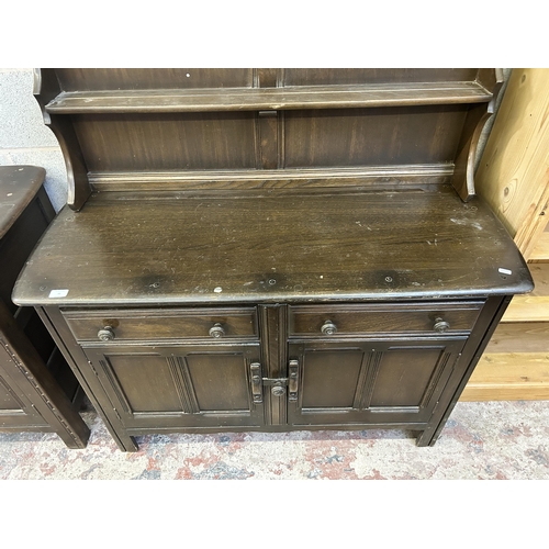 11 - An Ercol Old Colonial dark elm dresser - approx. 162cm high x 120cm wide x 48cm deep