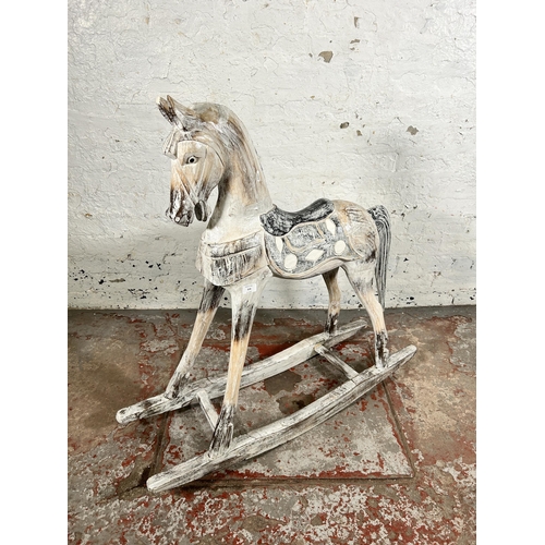 114 - A Victorian style carved hardwood and white painted rocking horse - approx. 97cm high x 28cm wide x ... 