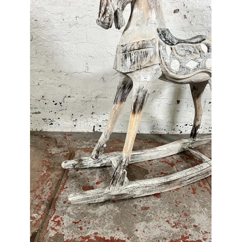 114 - A Victorian style carved hardwood and white painted rocking horse - approx. 97cm high x 28cm wide x ... 