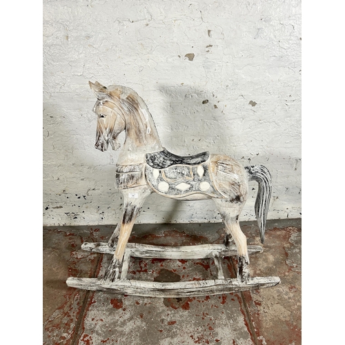 114 - A Victorian style carved hardwood and white painted rocking horse - approx. 97cm high x 28cm wide x ... 