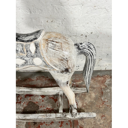 114 - A Victorian style carved hardwood and white painted rocking horse - approx. 97cm high x 28cm wide x ... 