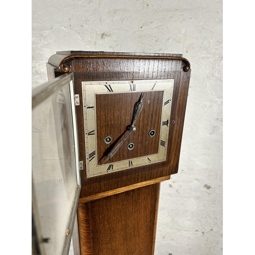 117 - An Art Deco oak cased Westminster chime granddaughter clock with key and pendulum - approx. 142cm hi... 