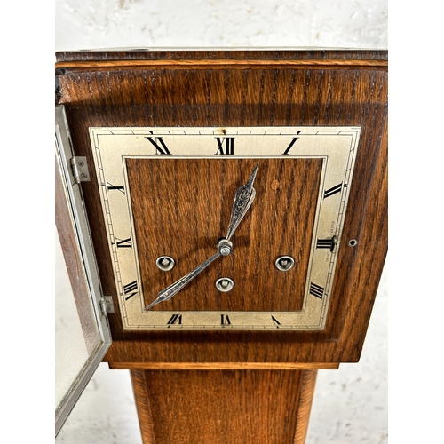 117 - An Art Deco oak cased Westminster chime granddaughter clock with key and pendulum - approx. 142cm hi... 