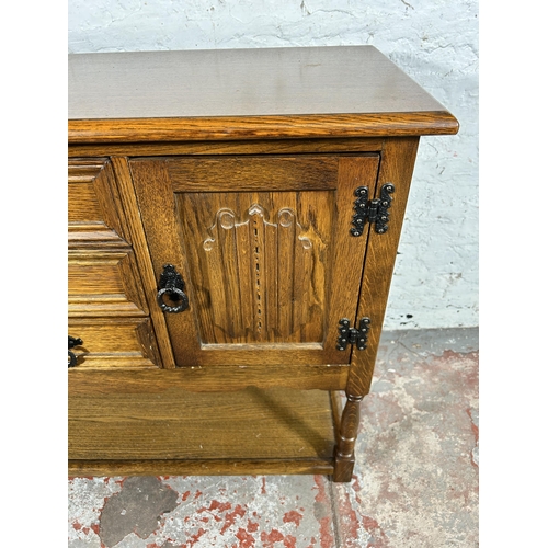 119 - A carved oak linenfold side cabinet - approx. 68cm high x 92cm wide x 37cm deep