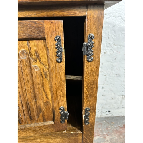 119 - A carved oak linenfold side cabinet - approx. 68cm high x 92cm wide x 37cm deep