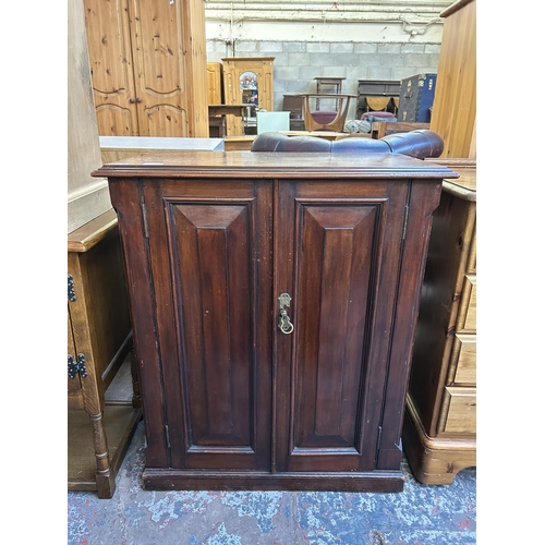 121 - A late 19th/early 20th century mahogany two door cabinet - approx. 82cm high x 69cm wide x 35cm deep