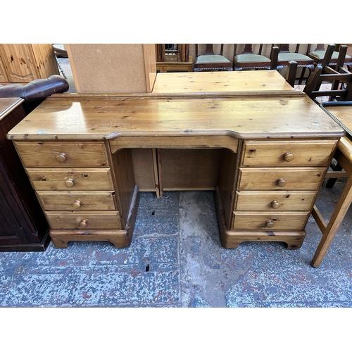 122 - A Ducal Victoria pine nine drawer dressing table - approx. 79cm high x 146cm wide x 45cm deep