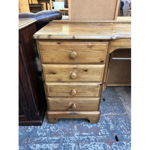 122 - A Ducal Victoria pine nine drawer dressing table - approx. 79cm high x 146cm wide x 45cm deep