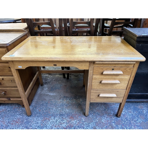 126 - A mid 20th century Abbess oak three drawer office desk - approx. 71cm high x 106cm wide x 60cm deep