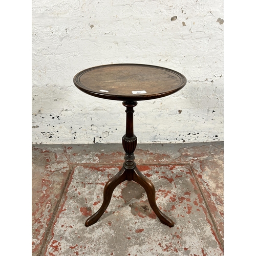 128 - A 19th century mahogany circular tripod wine table - approx. 64cm high x 36cm in diameter