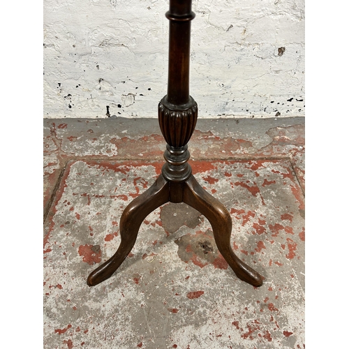 128 - A 19th century mahogany circular tripod wine table - approx. 64cm high x 36cm in diameter