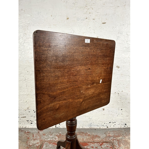 129 - A late 18th/early 19th century mahogany tilt top tripod occasional table - approx. 101cm high x 58cm... 