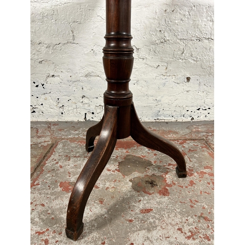 129 - A late 18th/early 19th century mahogany tilt top tripod occasional table - approx. 101cm high x 58cm... 