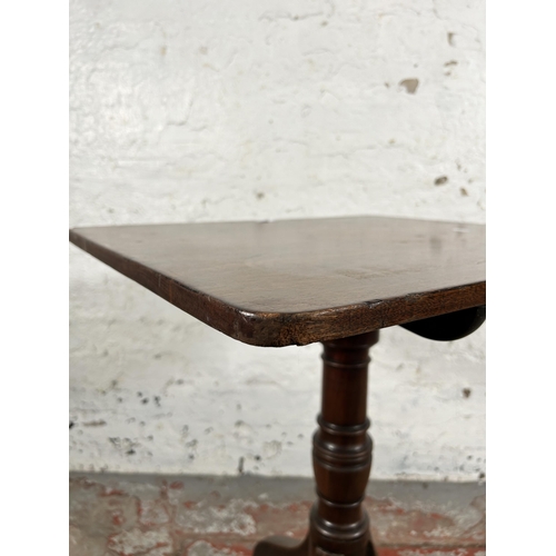 129 - A late 18th/early 19th century mahogany tilt top tripod occasional table - approx. 101cm high x 58cm... 