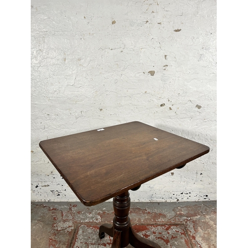 129 - A late 18th/early 19th century mahogany tilt top tripod occasional table - approx. 101cm high x 58cm... 