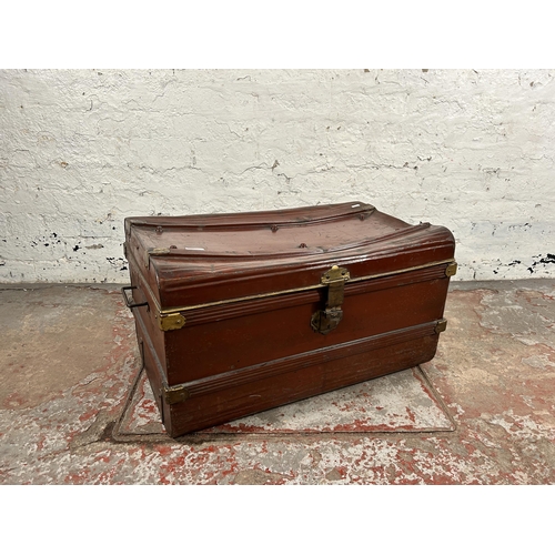 131 - An early 20th century red painted and brass bound travel trunk - approx. 39cm high x 70cm wide x 45c... 