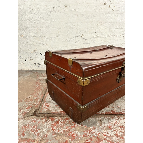 131 - An early 20th century red painted and brass bound travel trunk - approx. 39cm high x 70cm wide x 45c... 