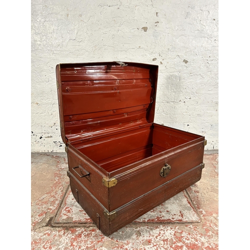 131 - An early 20th century red painted and brass bound travel trunk - approx. 39cm high x 70cm wide x 45c... 