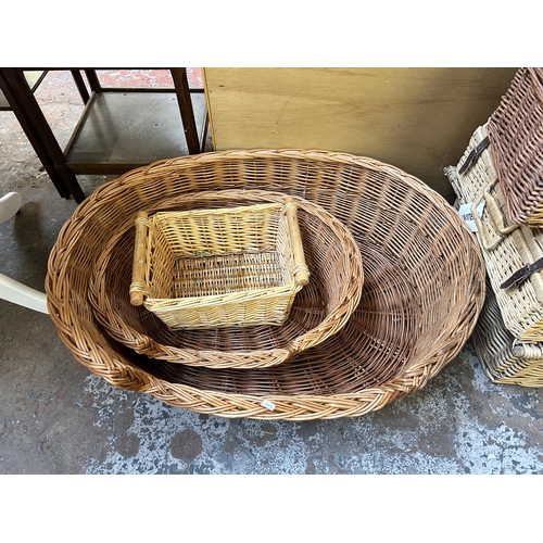 133 - Eleven pieces of wicker furniture, ten baskets and one armchair