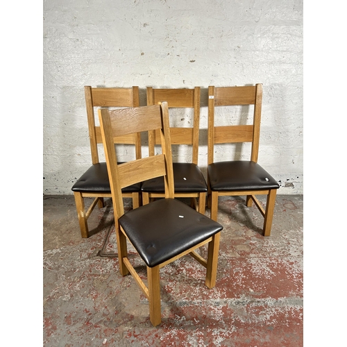 134 - Four modern oak and brown leatherette dining chairs