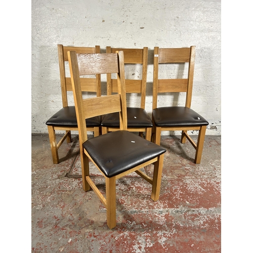 134 - Four modern oak and brown leatherette dining chairs