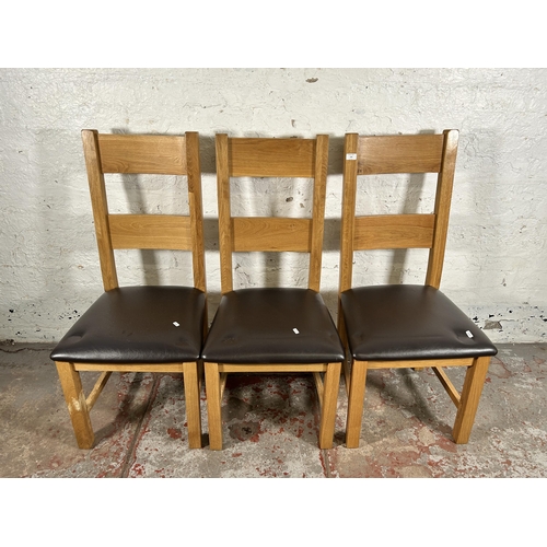 134 - Four modern oak and brown leatherette dining chairs