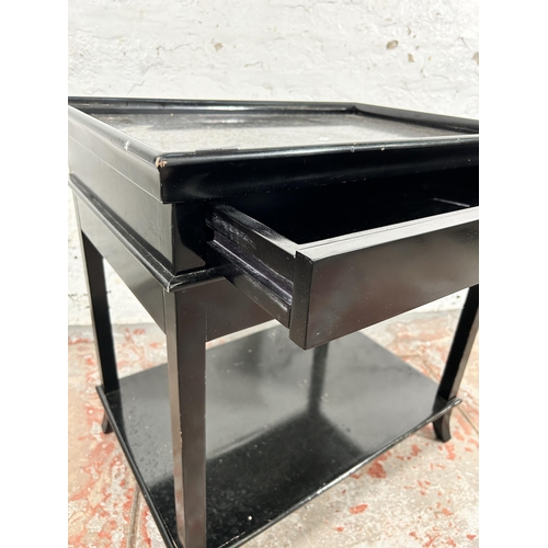 136 - A modern black painted single drawer two tier side table - approx. 67cm high x 65cm wide x 45cm deep