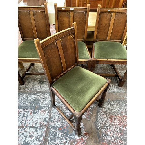 137 - Four 1930s carved oak and green fabric upholstered dining chairs