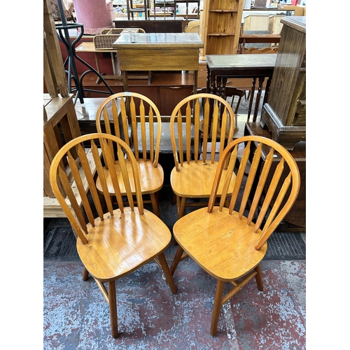 139 - Four beech Windsor dining chairs