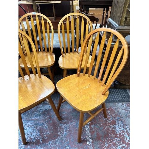 139 - Four beech Windsor dining chairs