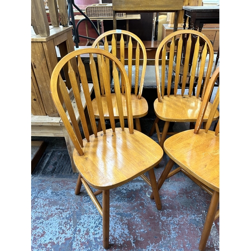 139 - Four beech Windsor dining chairs