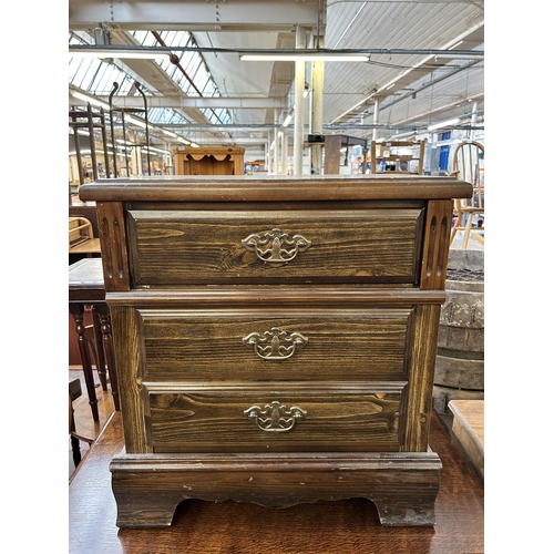 140 - A pine bedside chest of drawers - approx. 63cm high x 57cm wide x 36cm deep