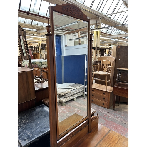 147 - An Edwardian carved mahogany dressing table with bevelled edge mirror and two drawers - approx. 183c... 