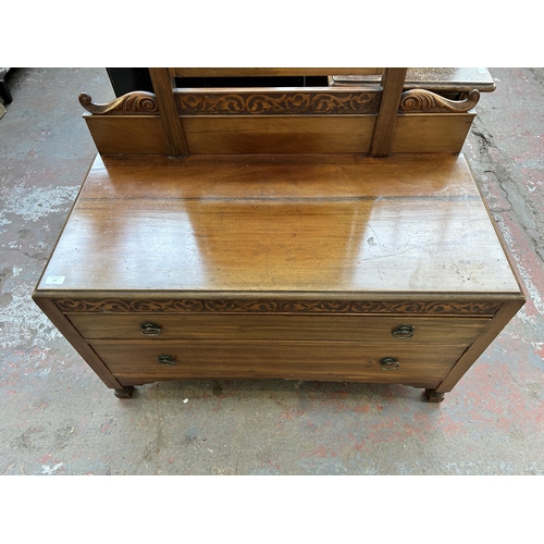 147 - An Edwardian carved mahogany dressing table with bevelled edge mirror and two drawers - approx. 183c... 