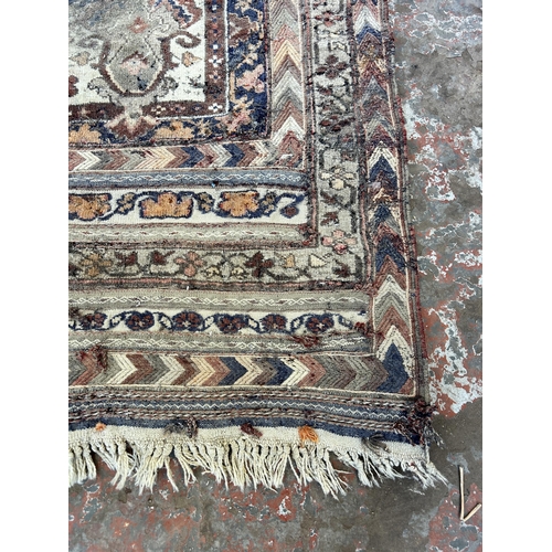 151B - An Afghan hand knotted rug - approx. 138cm x 125cm