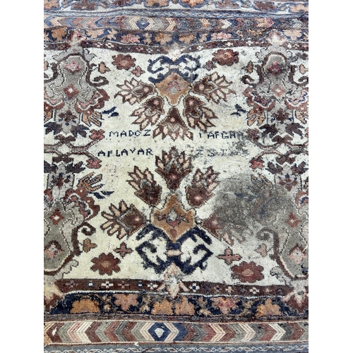 151B - An Afghan hand knotted rug - approx. 138cm x 125cm