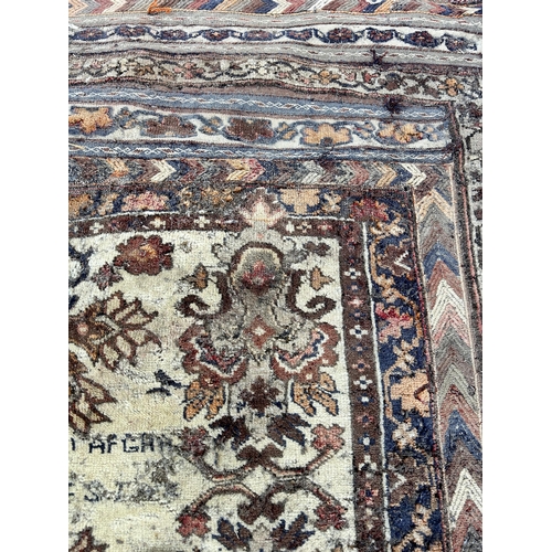 151B - An Afghan hand knotted rug - approx. 138cm x 125cm