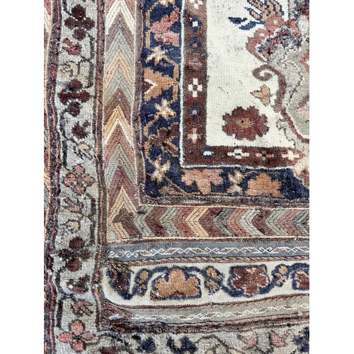 151B - An Afghan hand knotted rug - approx. 138cm x 125cm