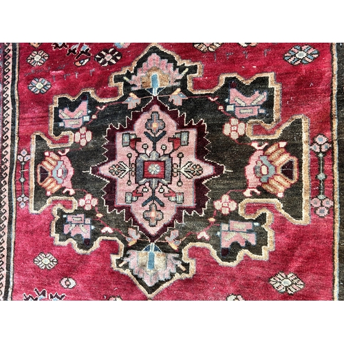 151C - A Persian hand knotted rug with signature - approx. 190cm x 166cm