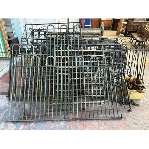 152 - A large quantity of cast and wrought iron garden gates and railings together with a box of hinges an... 