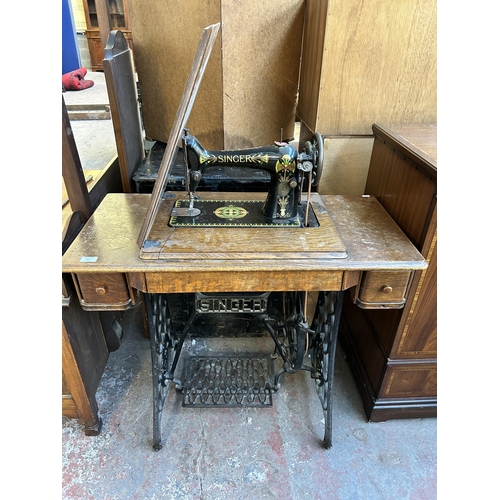 157 - A 1920 Singer cast iron and oak treadle sewing machine - serial no. F9848923