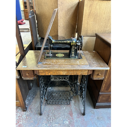 157 - A 1920 Singer cast iron and oak treadle sewing machine - serial no. F9848923