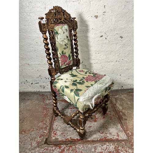 158 - A Victorian heavily carved and gilded occasional chair with floral upholstery