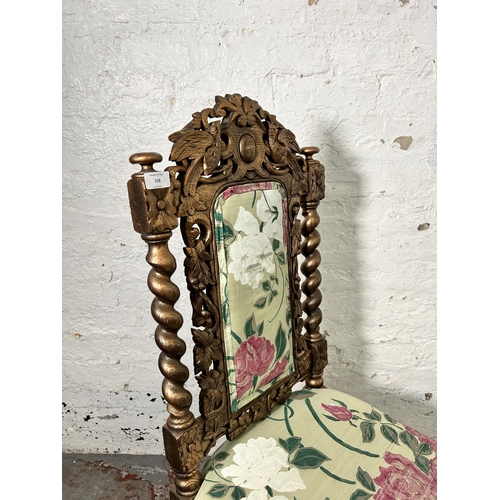 158 - A Victorian heavily carved and gilded occasional chair with floral upholstery