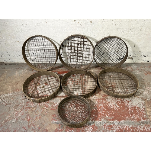 162 - Seven antique wooden and metal wired potato picking baskets - largest approx. 62cm high