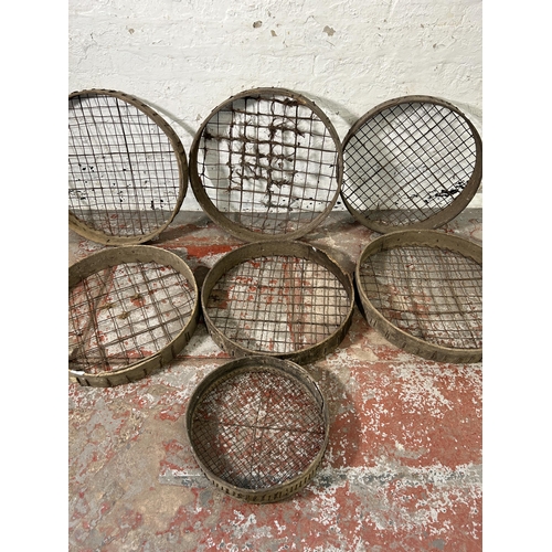 162 - Seven antique wooden and metal wired potato picking baskets - largest approx. 62cm high