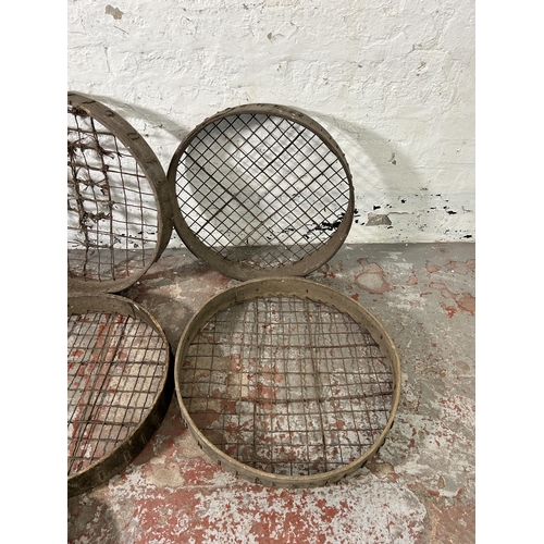 162 - Seven antique wooden and metal wired potato picking baskets - largest approx. 62cm high